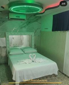 a bedroom with a bed with a frisbee on the ceiling at HOTEL FLORES LUCXON, ca in Caracas