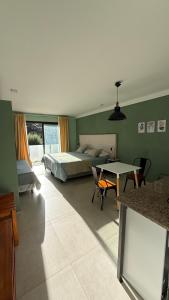 a bedroom with a bed and a table and chairs at Terracampo Apart in Ciudad Lujan de Cuyo