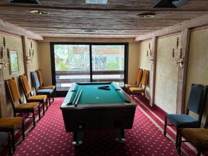 a billiard room with a pool table and chairs at Kronenlodge in Seefeld in Tirol