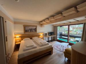 a bedroom with a bed and a large window at Kronenlodge in Seefeld in Tirol +37 photos