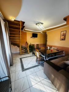 a living room with a table and a couch at Лісова казка in Yaremche