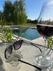 a glass of red wine sitting on top of a table at Reginahouse in Szigetszentmiklós