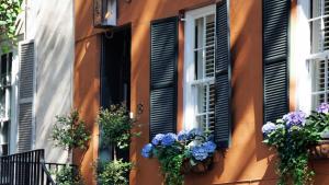 a building with flower boxes and shuttered windows at Hotel Indigo Savannah Historic District by IHG in Savannah