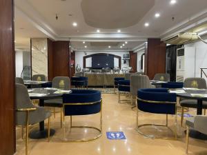 a restaurant with tables and chairs in a room at Verssailles Al Manar Hotel in Cairo