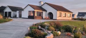 a house with a driveway in front of it at Atlantic Way Suites Doonbeg Co Clare in Doonbeg