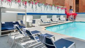 a swimming pool with lounge chairs and a table at The Royal Sonesta Washington DC Dupont Circle in Washington, D.C.