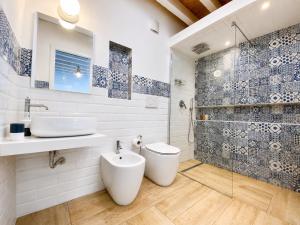 a bathroom with a sink and a toilet and a shower at Il Profumo del Mare GuestHouse in Cagliari