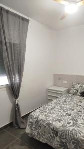a bedroom with a bed and a window at Loresti Mare in Fuengirola +5 photos