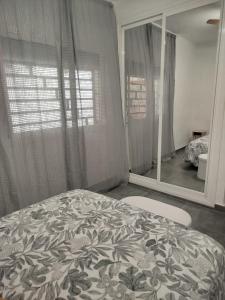 a bedroom with a bed and a large mirror at Loresti Mare in Fuengirola