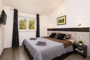 a bedroom with a bed and a window at Villa LM in Krnica +19 photos