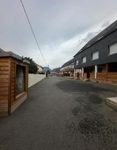 an empty street next to a row of buildings at Bel appartement sous combles in Argelès-Gazost