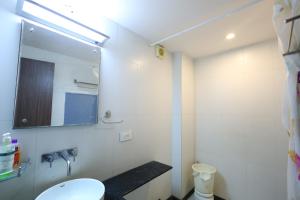 a bathroom with a sink and a mirror at MB hotel in Rajkot