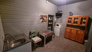 a small kitchen with a sink and a stove at Helme mõis in Helme