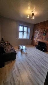 a living room with a couch and a coffee table at Helme mõis in Helme