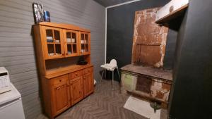 a kitchen with a wooden cabinet and a stove at Helme mõis in Helme