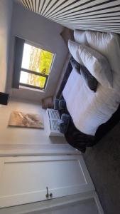 a bedroom with a bed with pillows and a window at Sea breeze house in Dog Island
