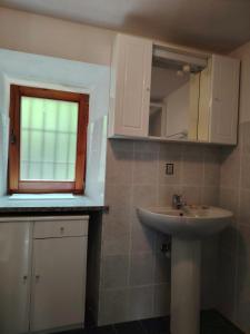 a bathroom with a sink and a window at Casa Allegra in Pont-Saint-Martin
