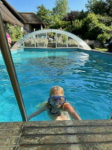 a woman in a swimming pool wearing goggles at Skovgaardsvej 7 in Udby +4 photos