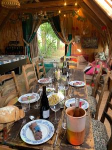 a wooden table with wine glasses and wine bottles at The Village in Anzat-le-Luguet +10 photos