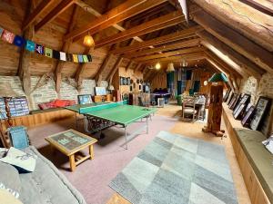 a living room with a ping pong table in it at The Village in Anzat-le-Luguet