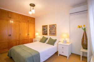 a bedroom with a white bed and two night stands at Bonito chalet en Valldemossa in Valldemossa