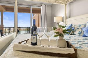a table with a bottle of wine and two glasses at Harborview Oasis in Clearwater Beach in Clearwater Beach