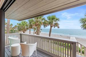 a balcony with chairs and a view of the beach at Beachfront Aldea 12 in Clearwater Beach