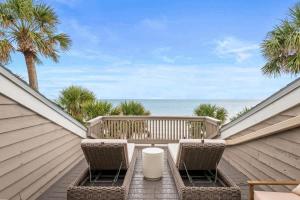 a patio with chairs and a view of the ocean at Beachfront Aldea 12 in Clearwater Beach