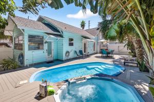 a house with a swimming pool in front of a house at Coastal Beach Retreat in Clearwater Beach