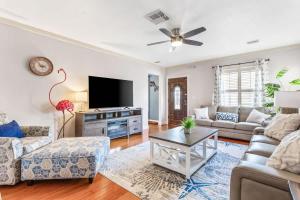 a living room with a couch and a tv at Coconut Beach House in Clearwater Beach