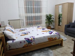 a bedroom with a bed with a white comforter at Il SORRISO in Moie