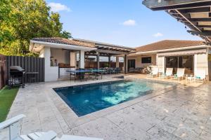 a swimming pool in the backyard of a house at Sunset Villa w Pool, Outdoor kitchen & Grill in Hialeah