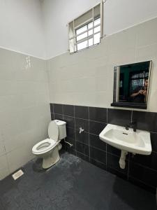 a bathroom with a toilet and a sink at DeSyafiq Homestay in Kuala Kedah