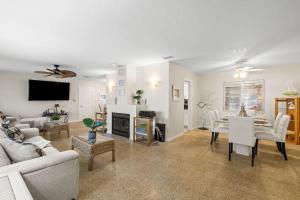 a living room with white furniture and a fireplace at Sunset Beach House in Clearwater Beach