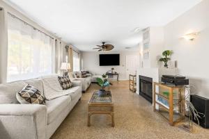 a living room with a couch and a tv at Sunset Beach House in Clearwater Beach