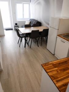 a kitchen and dining room with a table and chairs at Nuit étoilée - Dormir Comme A La Maison in Saint-Julien-de-Vouvantes