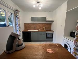 a kitchen with a table and a counter top at La Maison de Miel in Beynat +11 photos