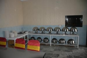 a room with a bunch of silver helmets on a shelf at Hotel Hills City, Swat in Mingāora