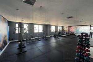 a gym with exercise equipment and a wall with graffiti at Flat Guarulhos - 4 in Guarulhos