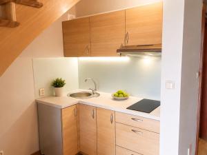 a kitchen with a sink and a bowl of fruit at Leśne Zacisze in Iława +20 photos