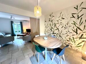 a dining room with a wooden table and chairs at La Maison de Miel in Beynat