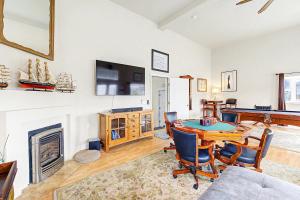 a living room with a table and a fireplace at Harbor SeaShell in Lincoln City +39 photos