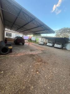a parking lot with cars parked under a roof at Hotel e restaurante Camicia in Maximiliano de Almeida +9 photos