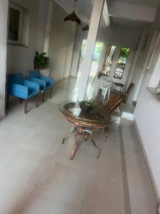 a living room with a table and chairs at Hotel e restaurante Camicia in Maximiliano de Almeida
