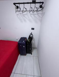 a room with a bed and two bags of luggage at Studio Brasil 861 in Lima +18 photos