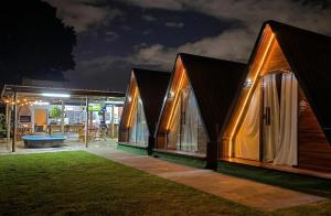 a house with windows and a patio at night at 2205 Chalé Suíte Pousada CadClube in Sao Jose do Rio Preto