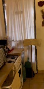 a kitchen with a stove top oven next to a window at Casa tranquila Paso de la Patria in Paso de la Patria