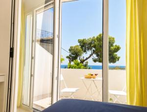 a bedroom with a view of the ocean at Kalimera Aegina in Agia Marina Aegina +45 photos