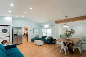 a living room with a blue couch and a table at Starfish Beach House in Clearwater Beach
