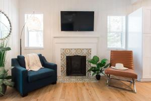 a living room with a blue chair and a fireplace at Starfish Beach House in Clearwater Beach +65 photos